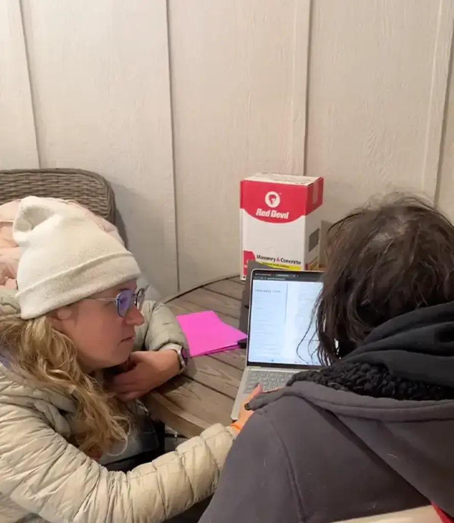 Clutch staff member working with a client community in the field